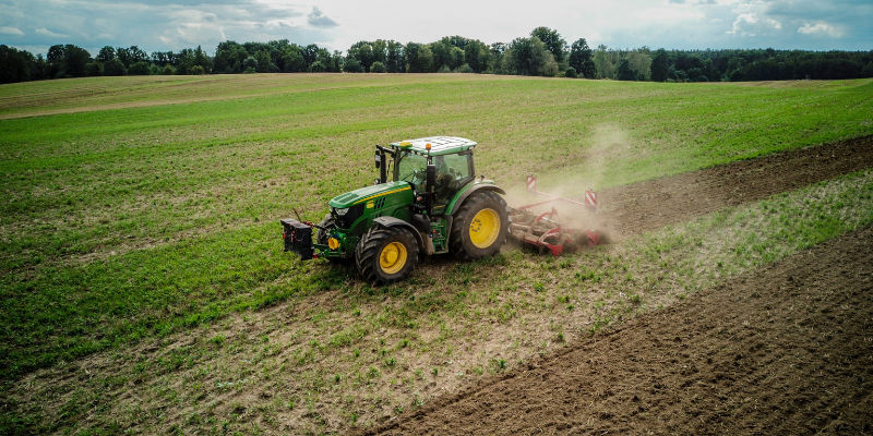 a tractor tending to a farm field